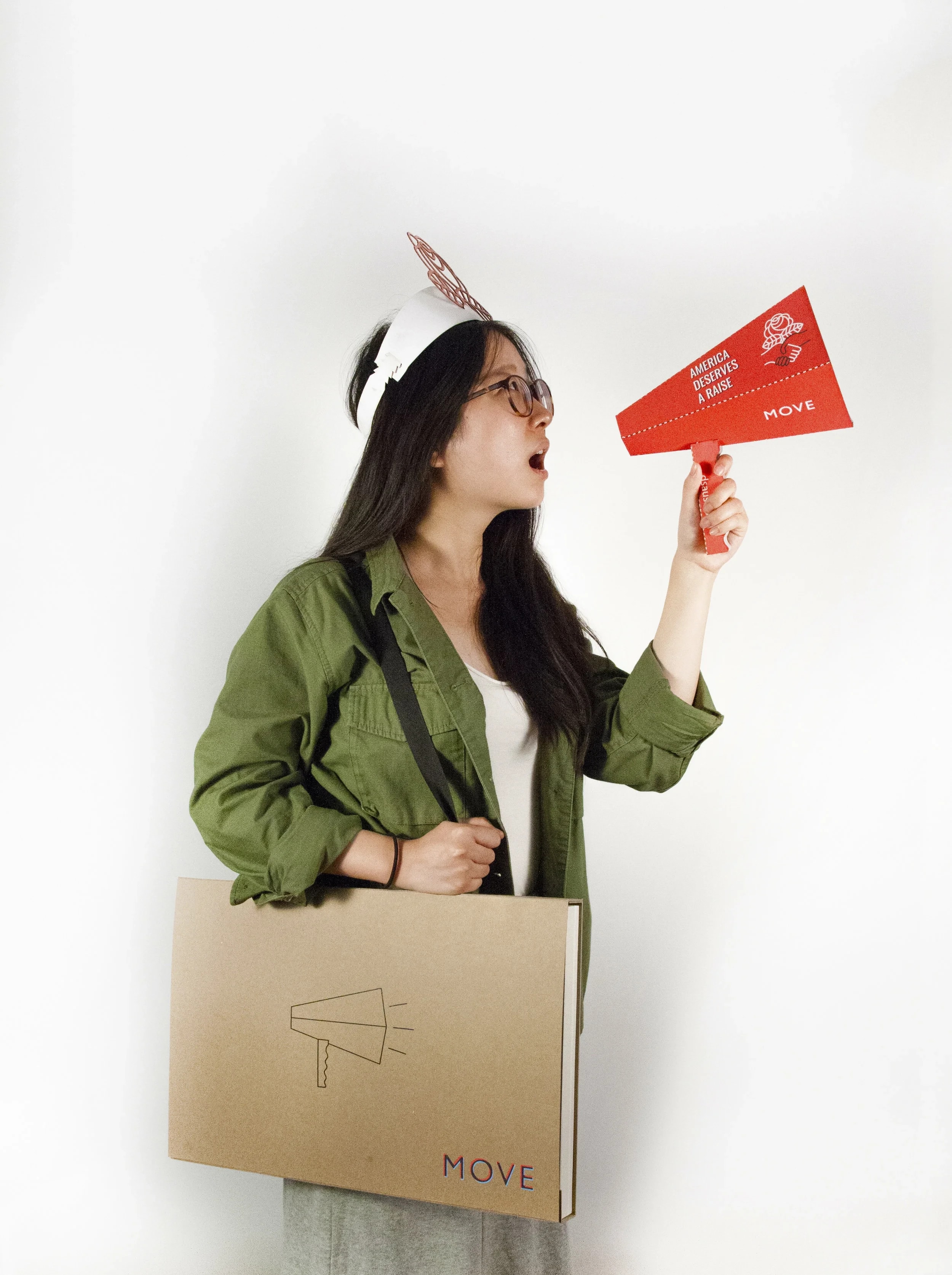A model holding the flat-pack megaphone and folio, part of the hypothetical DSA product line