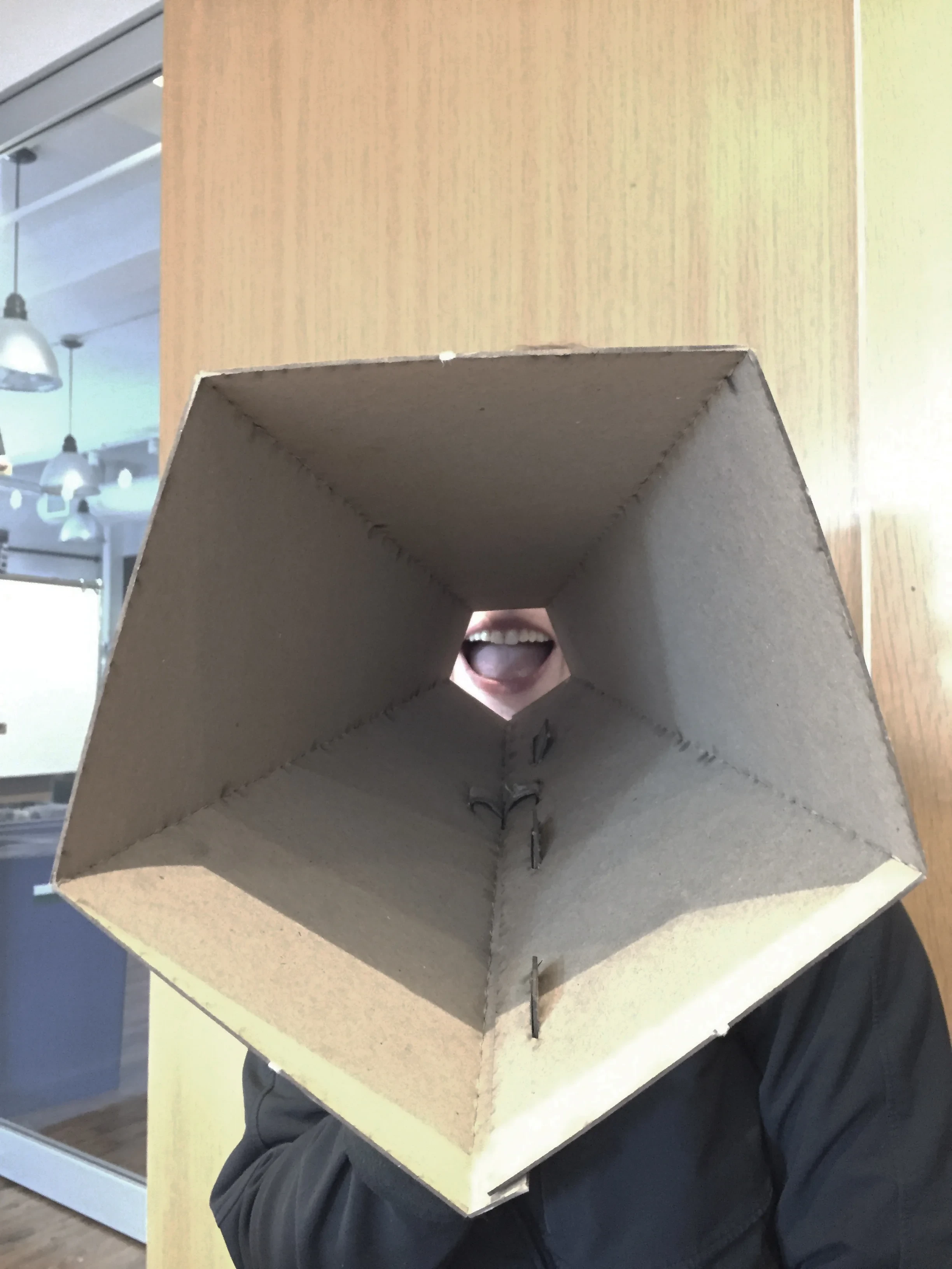 A teammate wearing an early cardboard prototype visor, branded "Lawless"
