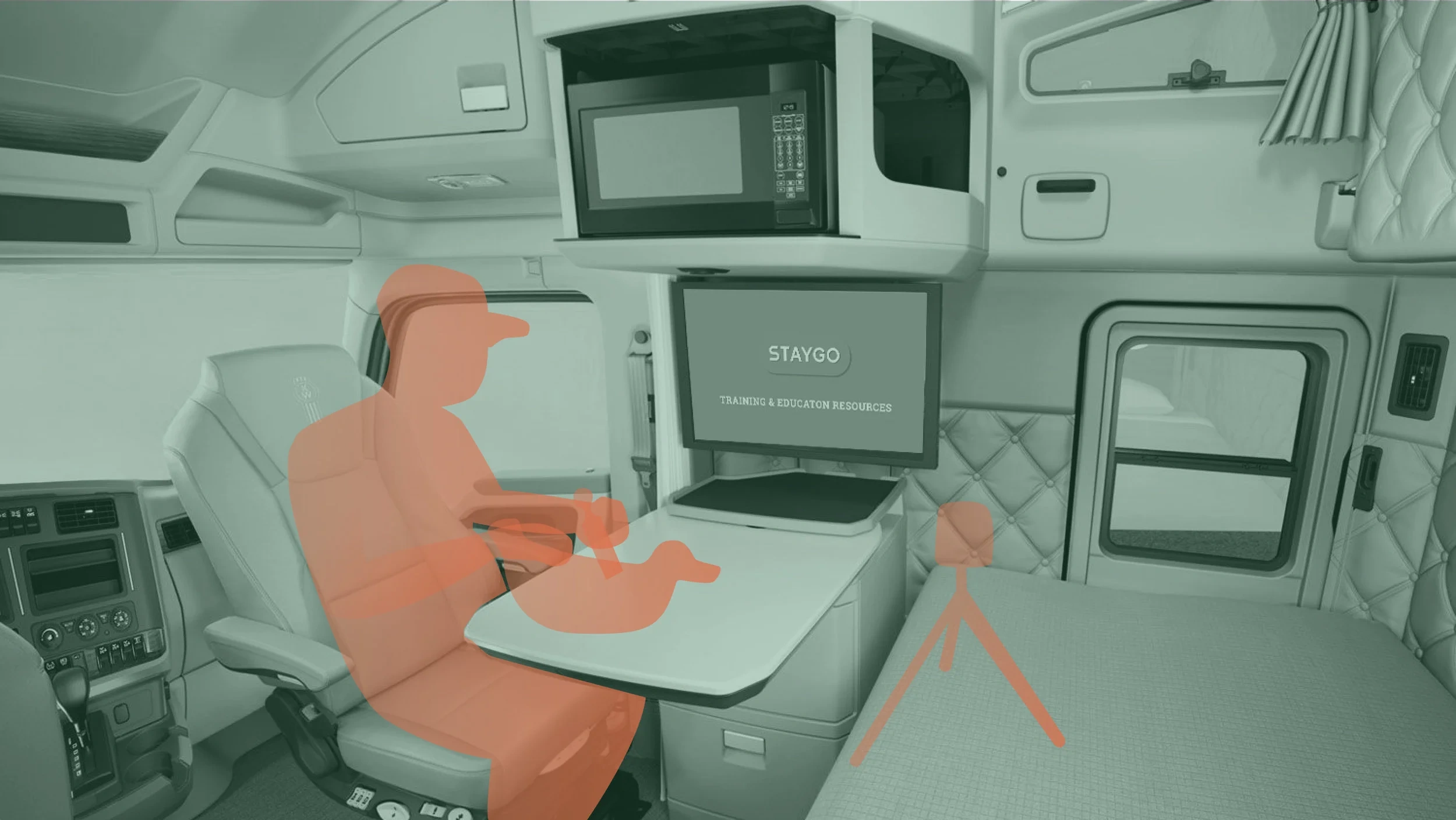 A StayGo truck cab's sleeper compartment, reimagined as a mobile office with a desk and monitor