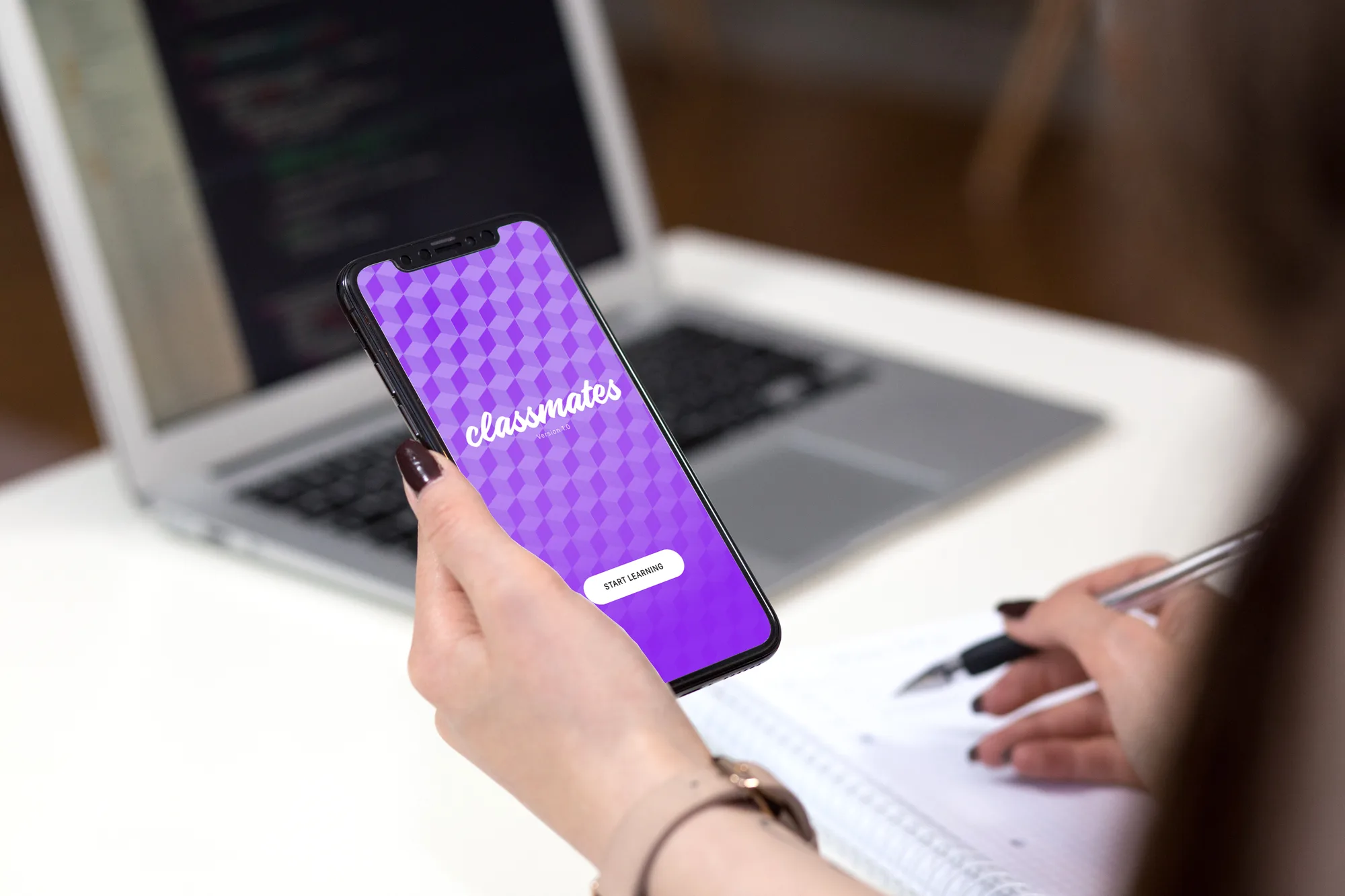 Classmates, a chatbot app for career-changers, shown in hand